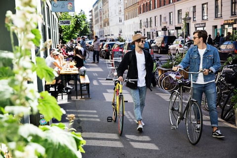 Men in street with city bikes